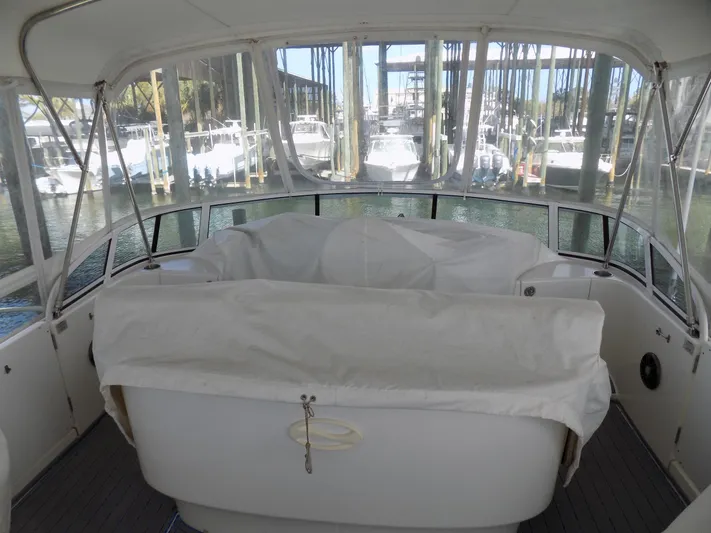  Yacht Photos Pics 2005 Silverton 43 Motor Yacht interior with covered seating, docked at marina.