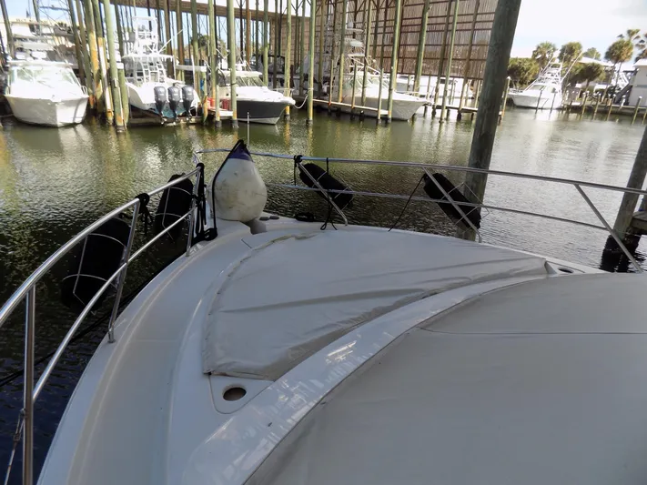  Yacht Photos Pics 2005 Silverton 43 Motor Yacht docked in a marina, surrounded by other boats.