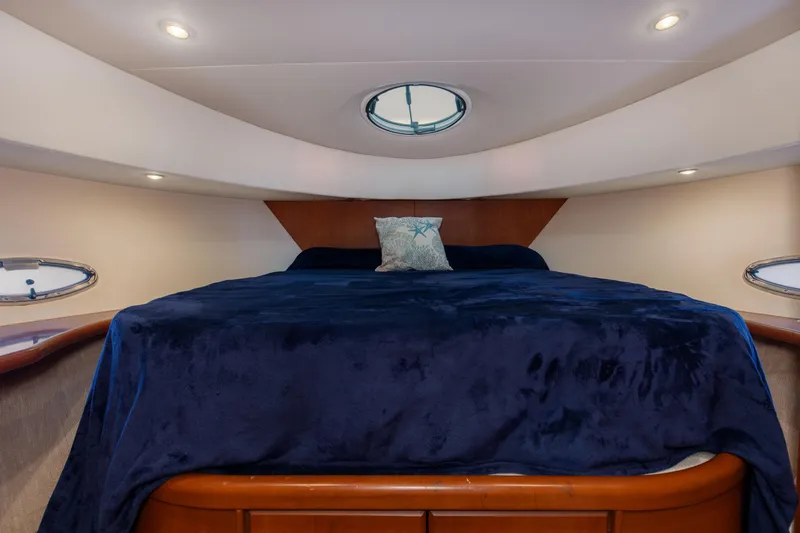  Yacht Photos Pics Luxurious bedroom in 2005 Silverton 43 Motor Yacht with plush bedding and elegant lighting.