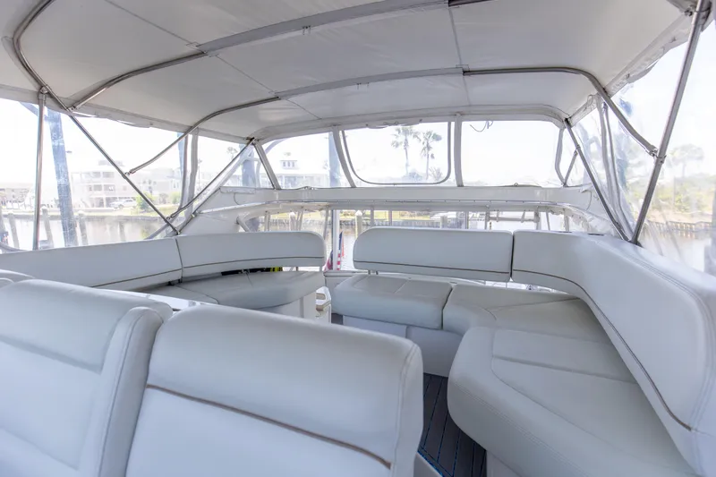  Yacht Photos Pics 2005 Silverton 43 Motor Yacht interior with white seating and panoramic windows.