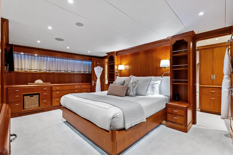 Silver Seas Yacht Photos Pics Luxurious 1998 Burger Raised Pilothouse yacht bedroom with elegant wood finishes and plush bedding.
