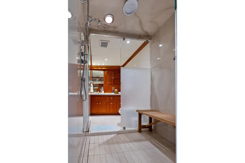 Silver Seas Yacht Photos Pics Luxurious shower area on 1998 Burger Raised Pilothouse yacht with wooden bench and modern fixtures.