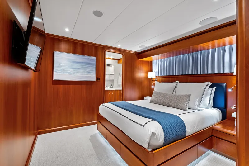 Silver Seas Yacht Photos Pics Luxurious bedroom interior on 1998 Burger Raised Pilothouse yacht, featuring elegant wood paneling.
