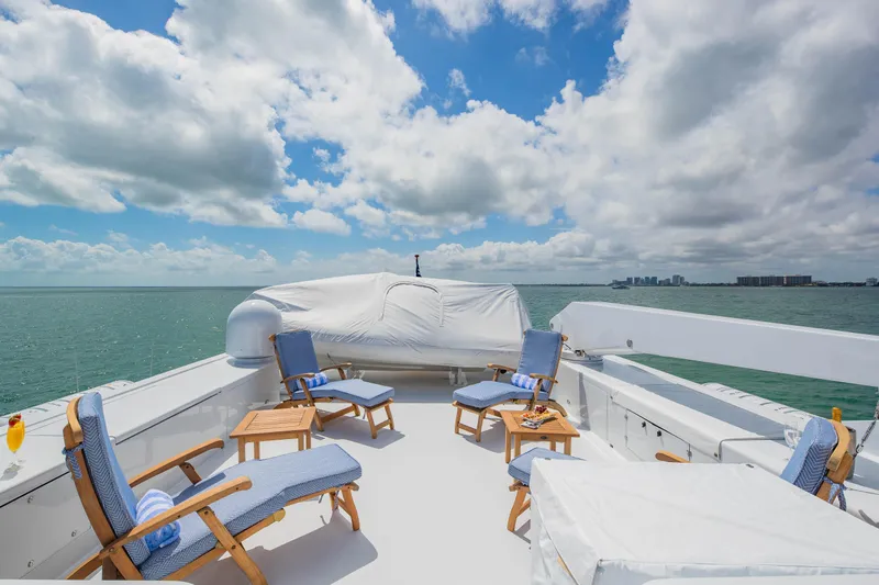 Silver Seas Yacht Photos Pics Luxurious 1998 Burger Raised Pilothouse yacht deck with ocean view and lounge chairs.