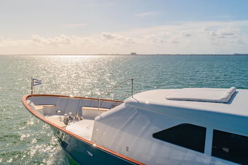 Silver Seas Yacht Photos Pics Luxurious 1998 Burger Raised Pilothouse yacht cruising on serene waters under a sunny sky.