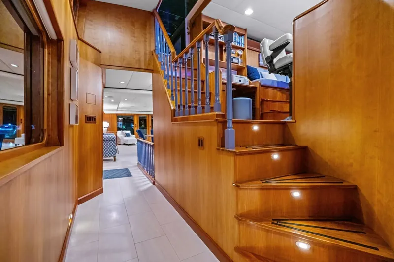 Silver Seas Yacht Photos Pics Luxurious 1998 Burger Raised Pilothouse yacht interior with wooden staircase and elegant furnishings.
