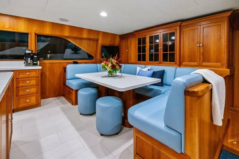 Silver Seas Yacht Photos Pics Luxurious 1998 Burger Raised Pilothouse yacht interior with elegant dining area and wooden cabinetry.