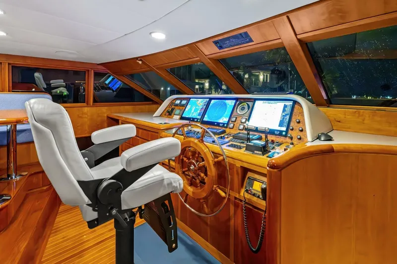 Silver Seas Yacht Photos Pics Luxurious 1998 Burger Raised Pilothouse yacht interior with navigation equipment and captain's chair.