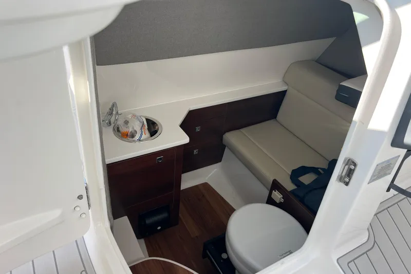  Yacht Photos Pics 2020 Chaparral 280 OSX boat interior with seating, sink, and toilet.