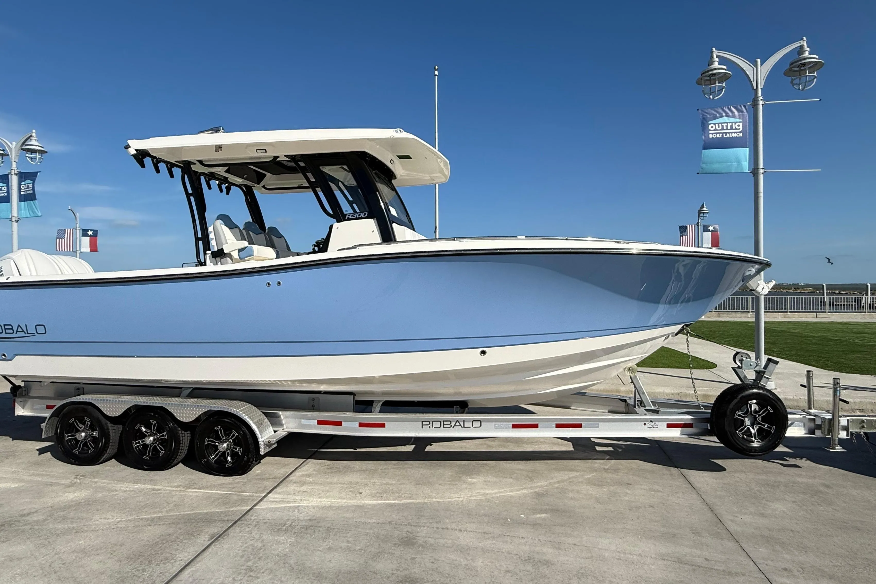 2025 Robalo R300 Center Console boat on trailer, displayed outdoors.