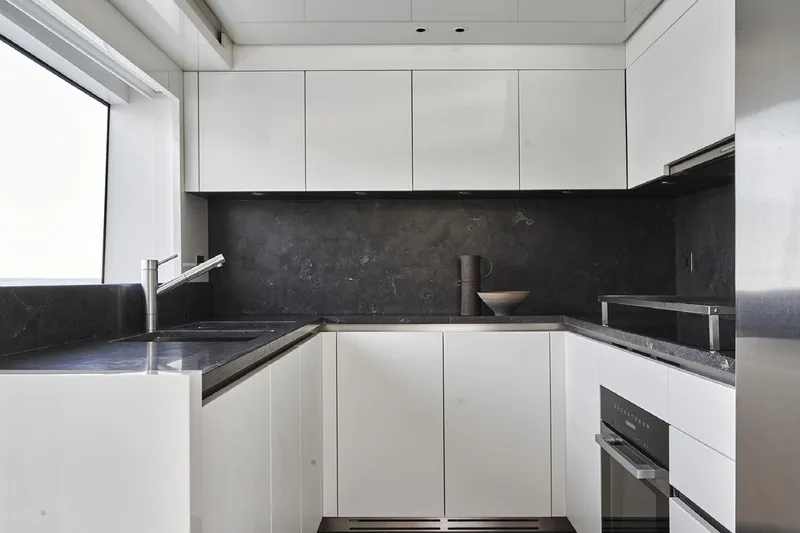 Sanlorenzo Sx88 Yacht Photos Pics Modern kitchen interior on 2025 Sanlorenzo SX88 yacht, featuring sleek white cabinetry.