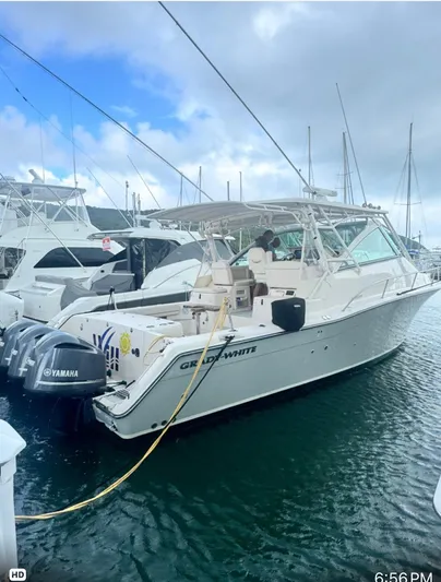  Yacht Photos Pics 2016 Grady-White Express 370 boat docked with Yamaha engines, under a cloudy sky.