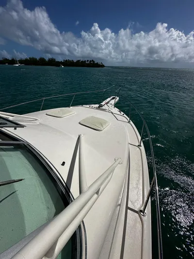  Yacht Photos Pics 2016 Grady-White Express 370 boat cruising on clear blue waters under a cloudy sky.