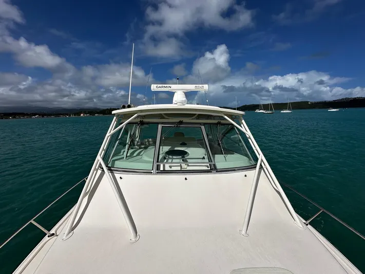  Yacht Photos Pics 2016 Grady-White Express 370 boat on turquoise water under a partly cloudy sky.