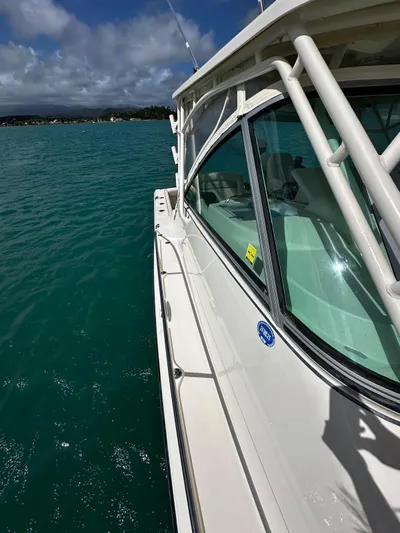  Yacht Photos Pics 2016 Grady-White Express 370 boat on turquoise water under a partly cloudy sky.