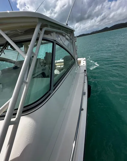  Yacht Photos Pics 2016 Grady-White Express 370 boat on calm turquoise water under cloudy sky.