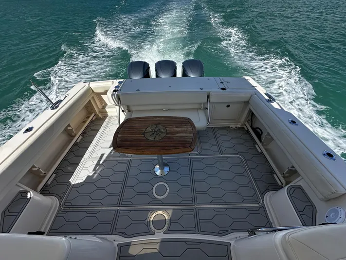  Yacht Photos Pics 2016 Grady-White Express 370 boat deck with table, cruising on open water.