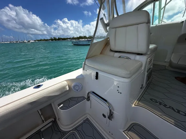  Yacht Photos Pics 2016 Grady-White Express 370 boat interior with seating, on turquoise water under blue sky.