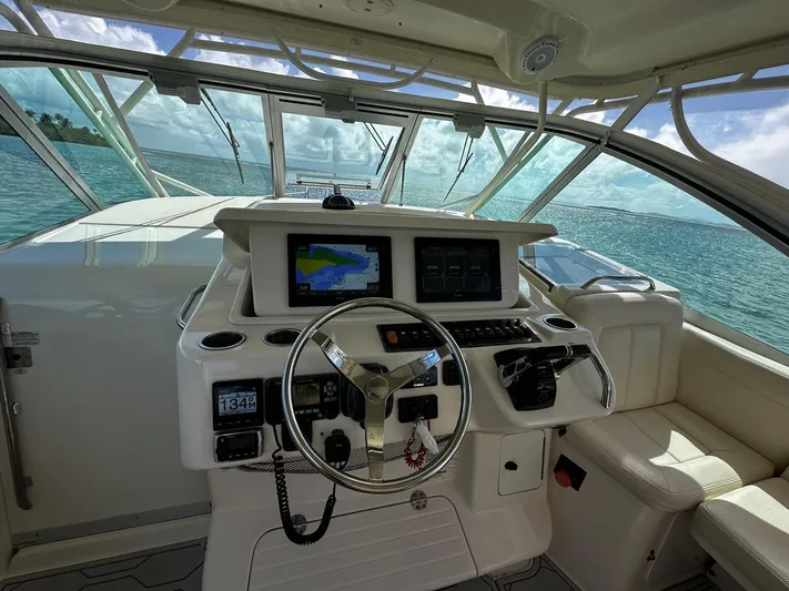  Yacht Photos Pics 2016 Grady-White Express 370 helm with navigation screens, steering wheel, and ocean view.