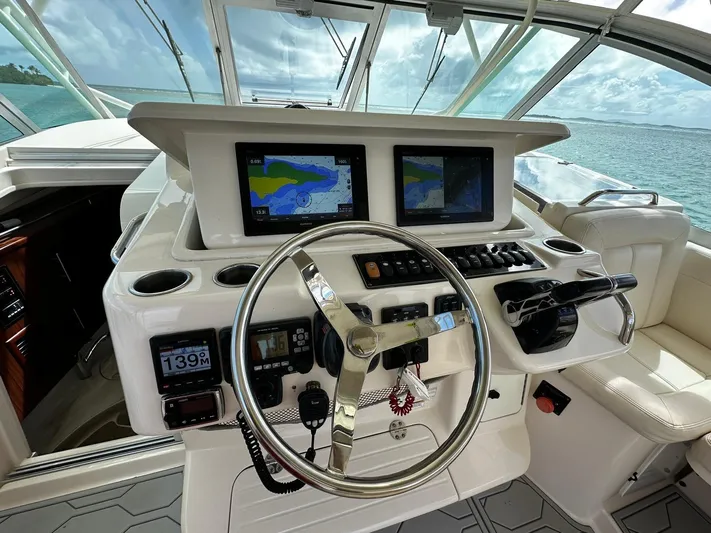  Yacht Photos Pics 2016 Grady-White Express 370 helm with dual navigation screens and steering wheel, overlooking the ocean.