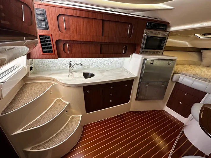  Yacht Photos Pics Luxurious 2016 Grady-White Express 370 cabin interior with kitchenette, stairs, and cozy sleeping area.