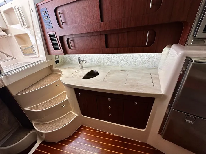  Yacht Photos Pics 2016 Grady-White Express 370 interior with wooden cabinetry and compact kitchen area.