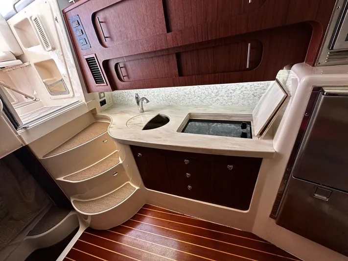  Yacht Photos Pics 2016 Grady-White Express 370 interior with kitchenette, wooden cabinets, and steps.