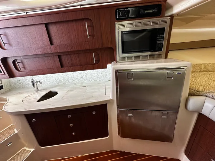  Yacht Photos Pics 2016 Grady-White Express 370 interior kitchen with microwave, sink, and storage cabinets.