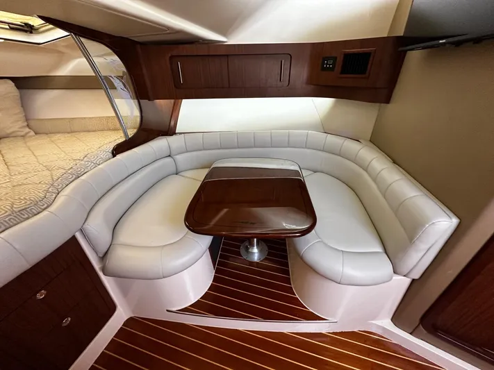  Yacht Photos Pics 2016 Grady-White Express 370 interior with elegant seating and wooden table.