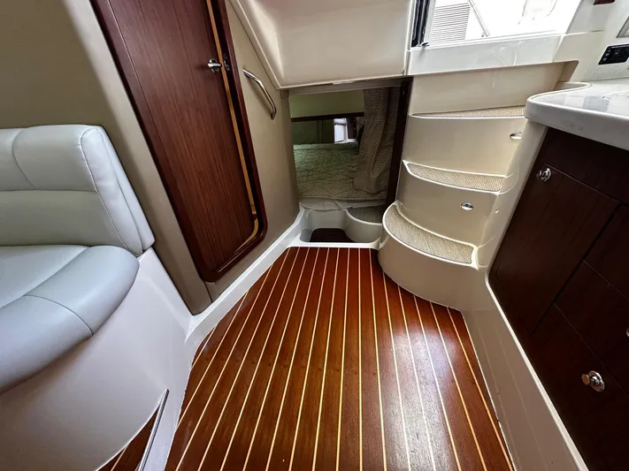  Yacht Photos Pics Interior of 2016 Grady-White Express 370 boat with wooden flooring and curved stairs.