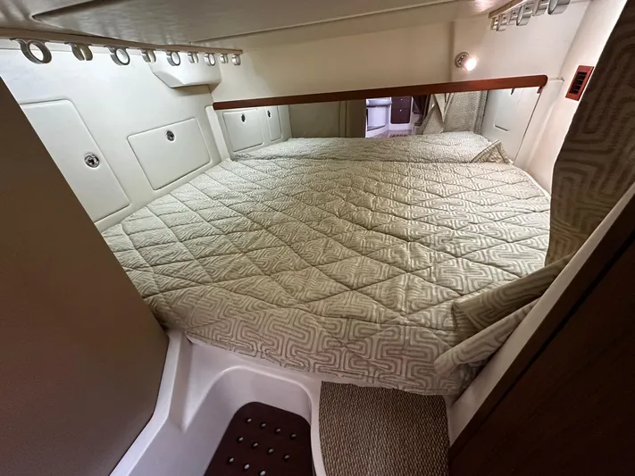  Yacht Photos Pics 2016 Grady-White Express 370 cabin interior with a cozy bed and modern design.