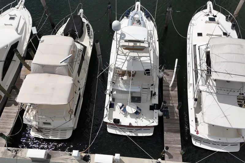  Yacht Photos Pics Overhead view of a 1988 Bertram 43 Flybridge yacht docked among other boats.