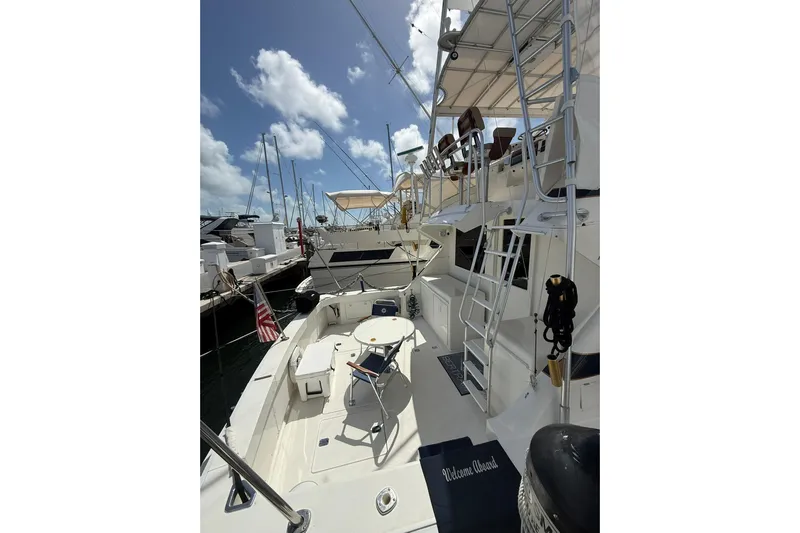  Yacht Photos Pics 1988 Bertram 43 Flybridge yacht docked, featuring spacious deck and seating area.