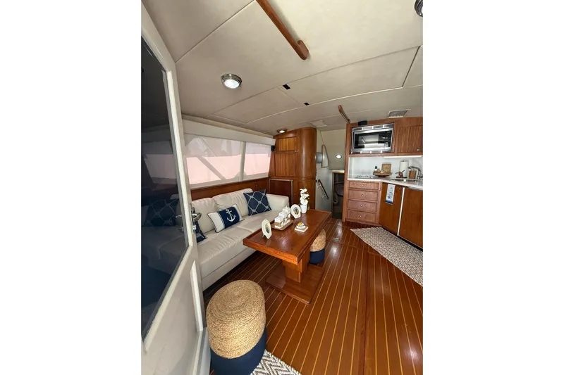  Yacht Photos Pics Interior of 1988 Bertram 43 Flybridge yacht with wooden furnishings and nautical decor.