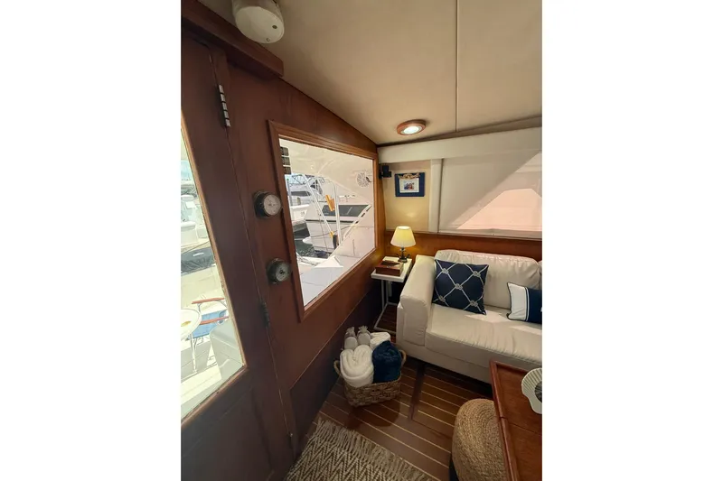  Yacht Photos Pics Interior of 1988 Bertram 43 Flybridge with cozy seating and nautical decor.