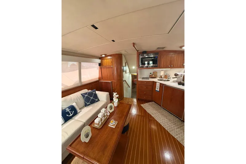  Yacht Photos Pics Luxurious interior of 1988 Bertram 43 Flybridge yacht with elegant wood finishes.