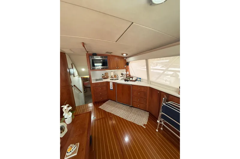  Yacht Photos Pics Interior of 1988 Bertram 43 Flybridge yacht with wooden cabinetry and modern amenities.
