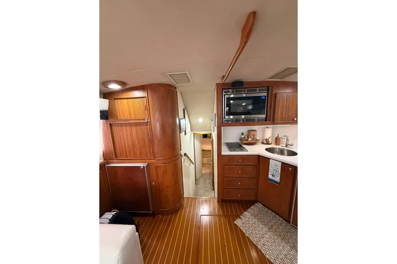  Yacht Photos Pics Interior of 1988 Bertram 43 Flybridge yacht with wood cabinetry and modern amenities.