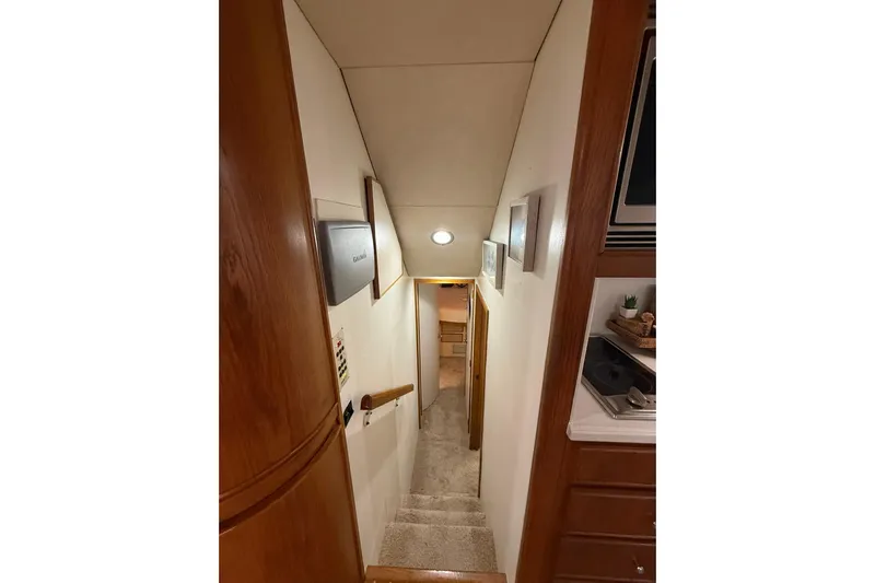  Yacht Photos Pics Interior view of 1988 Bertram 43 Flybridge yacht, showing stairs and hallway.