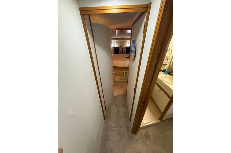  Yacht Photos Pics 1988 Bertram 43 Flybridge interior hallway with bedroom and bathroom view.