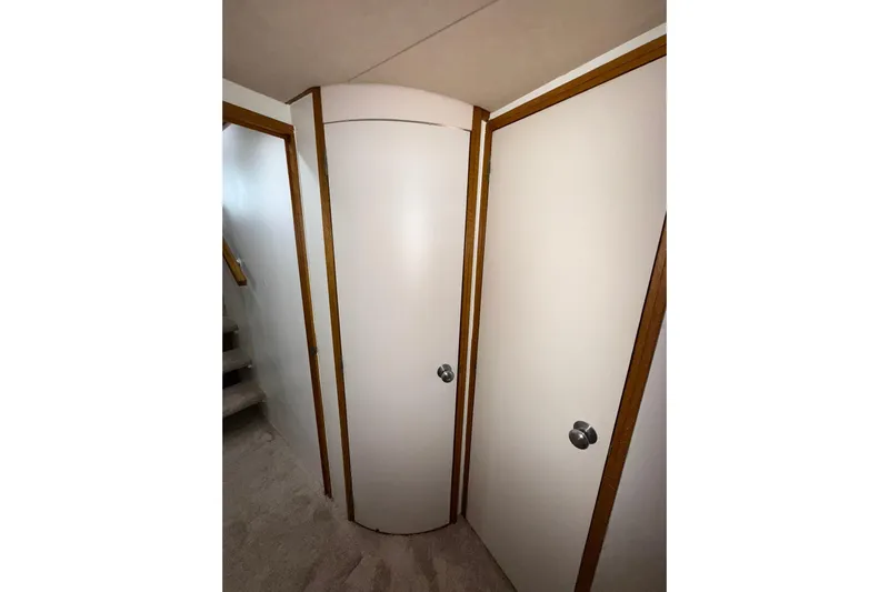  Yacht Photos Pics Interior view of 1988 Bertram 43 Flybridge, featuring white doors and wooden trim.