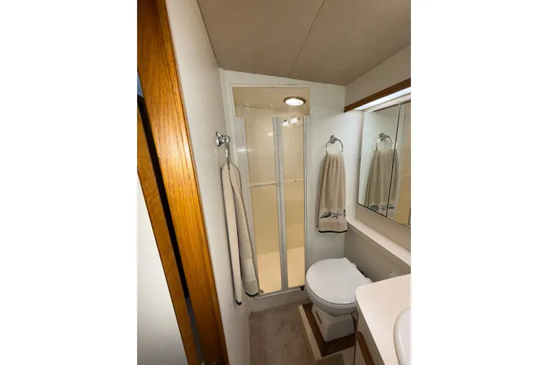  Yacht Photos Pics Bathroom interior of 1988 Bertram 43 Flybridge yacht with shower and toilet.