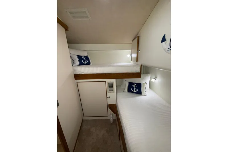  Yacht Photos Pics 1988 Bertram 43 Flybridge cabin with bunk beds and nautical-themed decor.