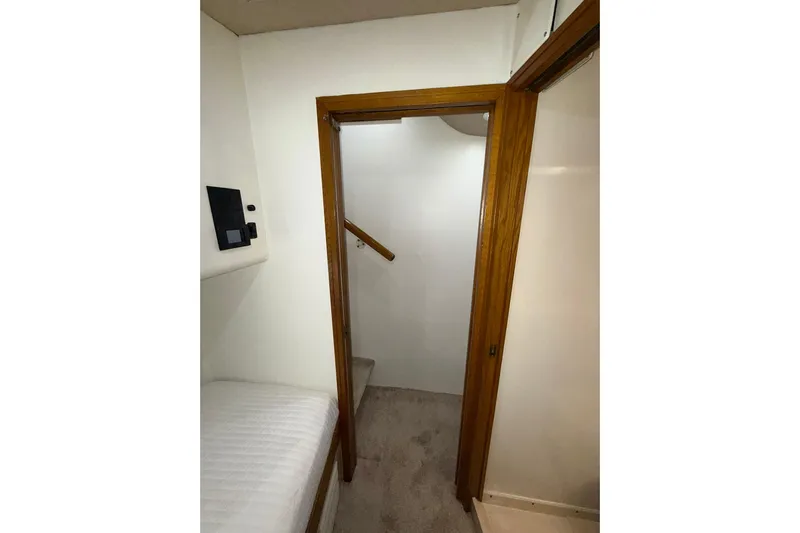  Yacht Photos Pics Interior view of 1988 Bertram 43 Flybridge, featuring a wooden door and carpeted stairs.