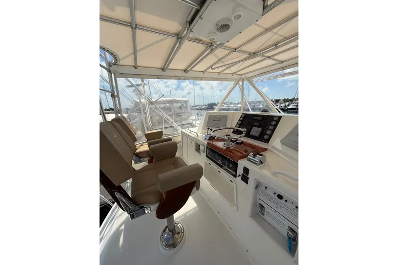  Yacht Photos Pics 1988 Bertram 43 Flybridge helm with dual seats and navigation controls.