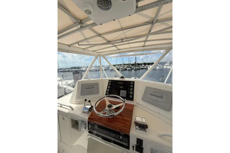  Yacht Photos Pics 1988 Bertram 43 Flybridge helm with Garmin navigation, overlooking marina.