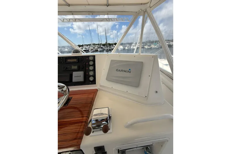  Yacht Photos Pics 1988 Bertram 43 Flybridge helm with Garmin navigation system, overlooking marina.