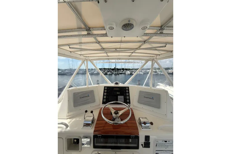  Yacht Photos Pics 1988 Bertram 43 Flybridge helm with Garmin navigation, overlooking marina.
