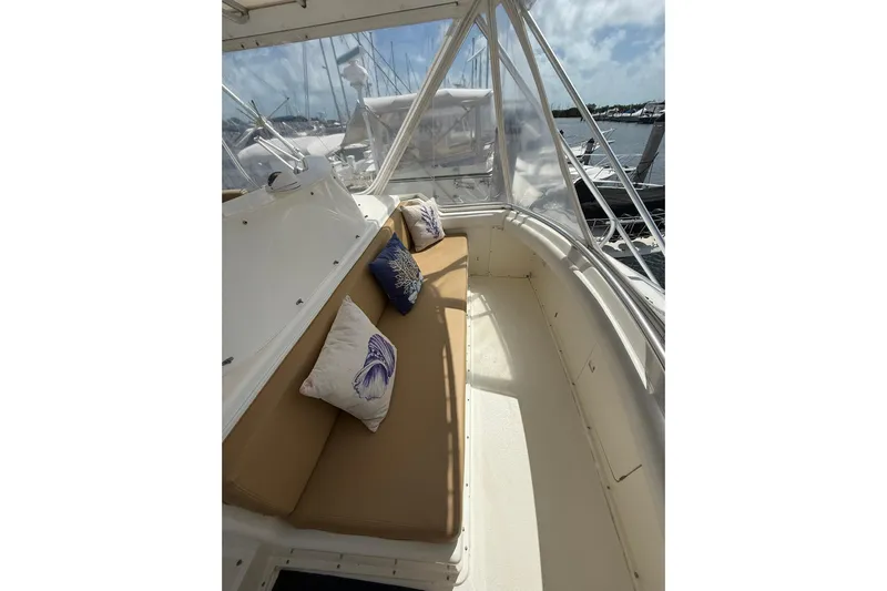  Yacht Photos Pics 1988 Bertram 43 Flybridge interior with cushioned seating and decorative pillows.