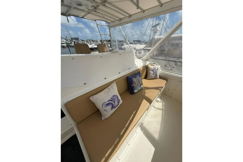  Yacht Photos Pics 1988 Bertram 43 Flybridge interior with cushioned seating and decorative pillows.